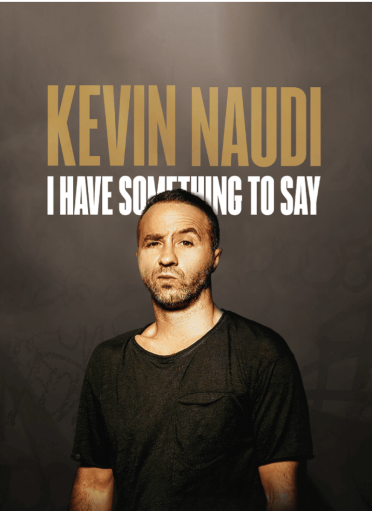 A man with a black t-shirt making a funny face