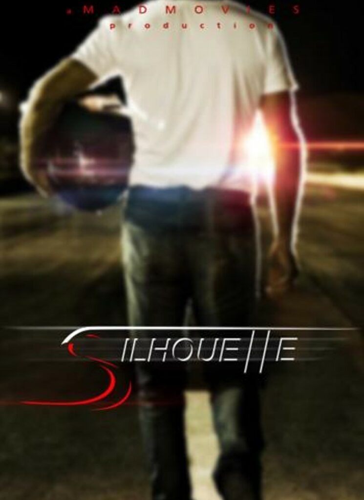 Man with his back facing front holding a helmet and the words Silhouette